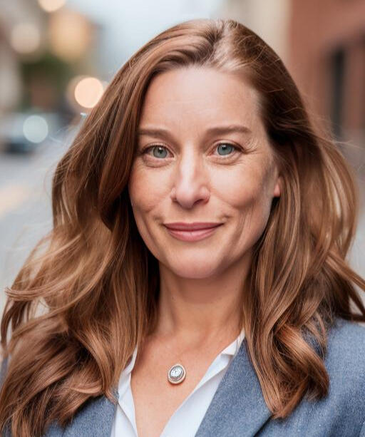 An image of Christine smiling toward the camera on a street in Lower Manhattan